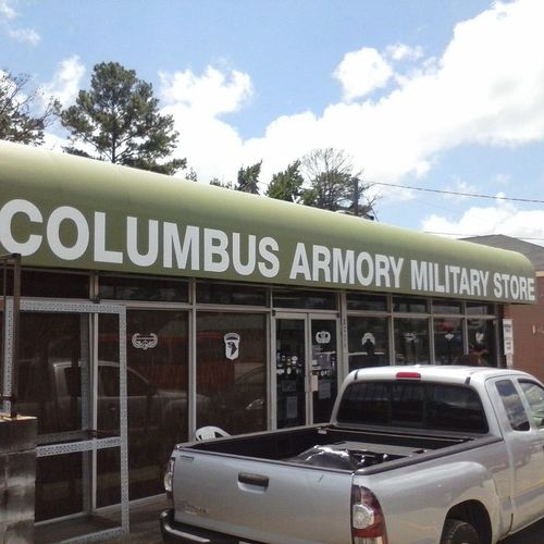 A large storefront awning reads 'Columbus Armory Military Store'