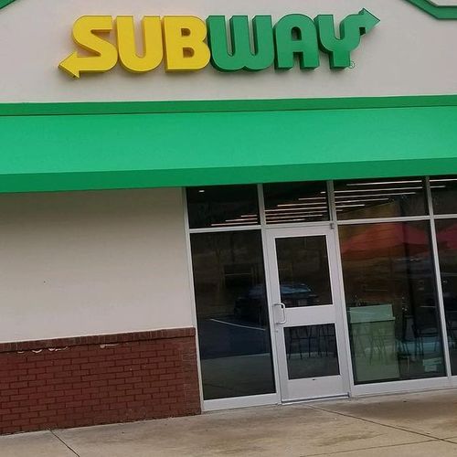 A walkway awning over the entrance to a Subway sandwich store