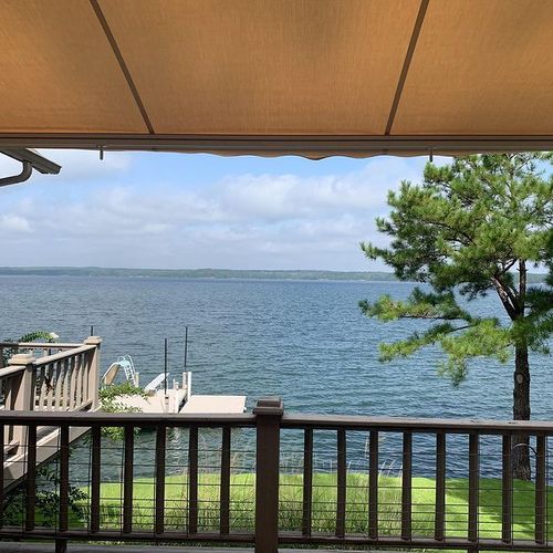 A view of a lake from a porch with a fabric cover