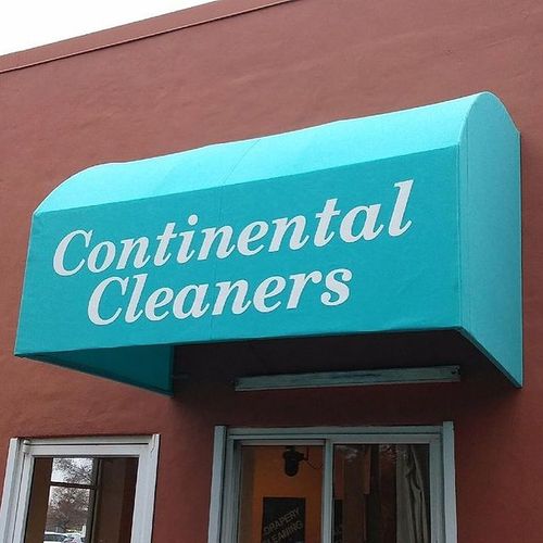An awning that reads 'Continental Cleaners' over a drive-through window