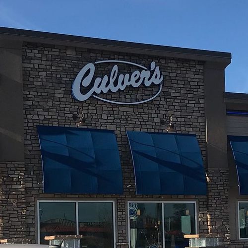 Several windows of a Culver's are covered by awnings