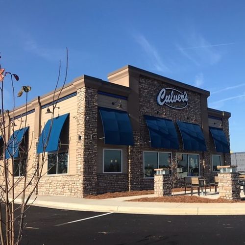 Several windows of a Culver's are covered by awnings