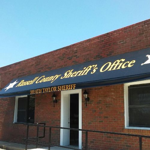 A long awning spans the walkway to Russel County Sheriff's Office - Heath Taylor Sheriff