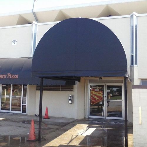 A large walkway awning in front of a Little Caesars Pizza