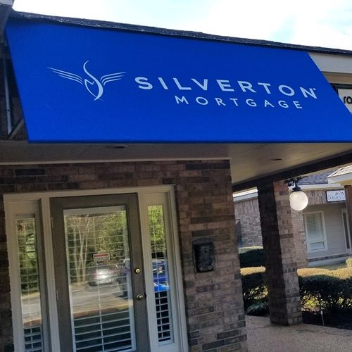 A small storefront awning shades the entrance to building. The awning reads 'Silverton Mortgage'