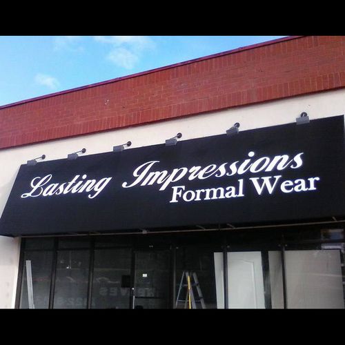 A long storefront awning reads 'Lasting Impressions Formal Wear'