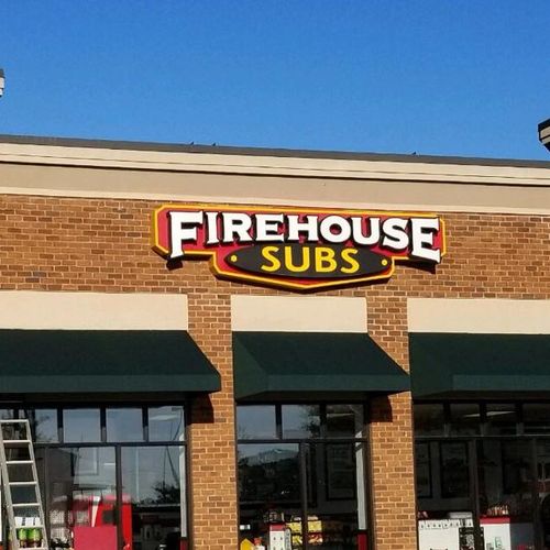 A Firehouse Subs restaurant featuring several door and window awnings