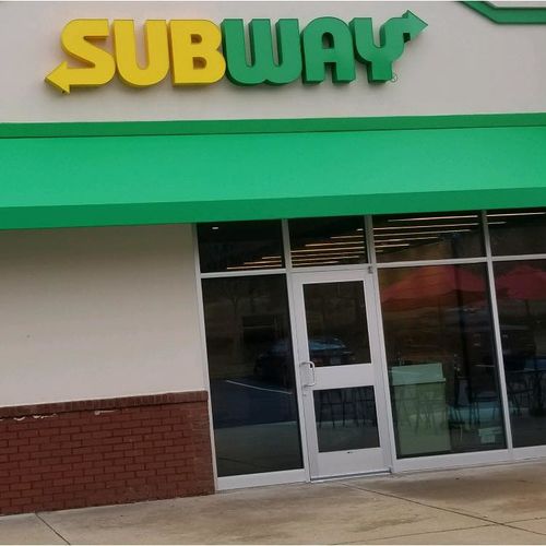 A walkway awning over the entrance to a Subway sandwich store