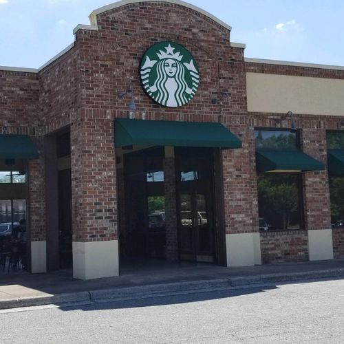 A starbucks building outfitted with several varieties of awnings