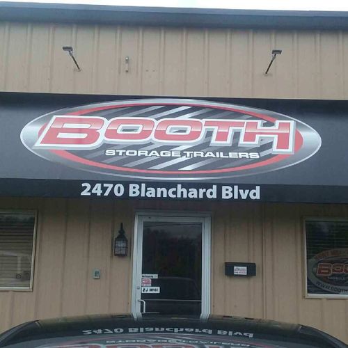 A door awning to a building reads 'Booth Storage Trailers - 2470 Blanchard Blvd.'