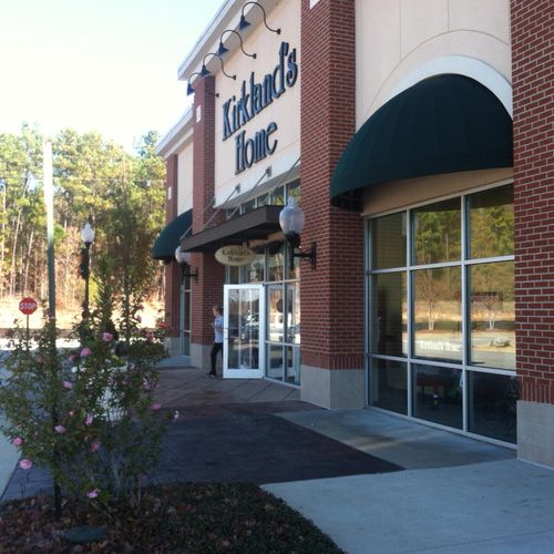 Several bullnose window awnings adorn a Kirkland's Home building