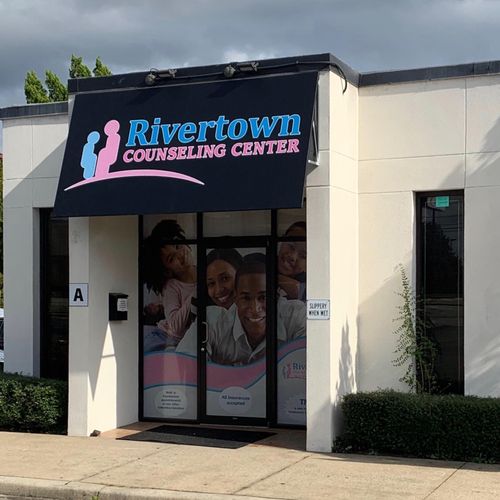 A storefront awning shades the entrance to Rivertown Counseling Center