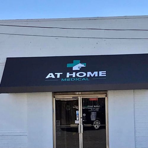 A doorway awning features a medical cross and reads At Home Medical