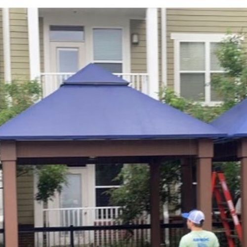 Several canopies shade a public space in an apartment complex