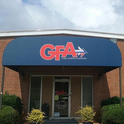 A large walkway cover shades the entrance to the GFA Total Logistics Solution building