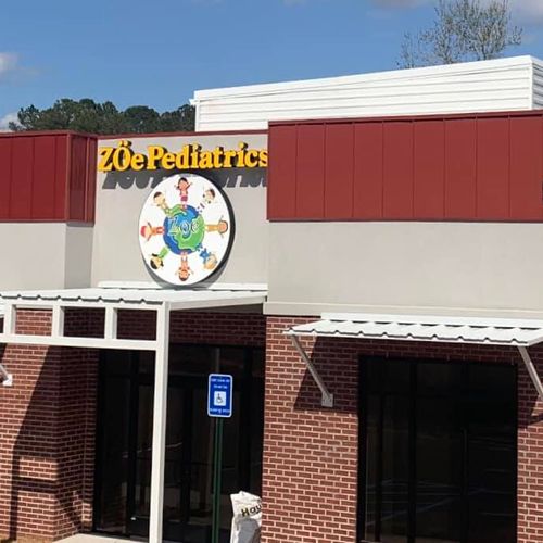 A metal awnings covers the entrances of the ZÖe Pediatrics building