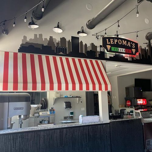 A striped interior awning covers the counter of Lepoma's Pizzeria