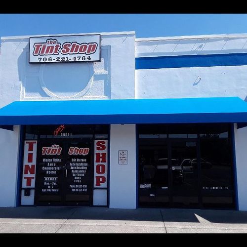 A storefront awning spans the entrance of The Tint Shop - 706-221-4764