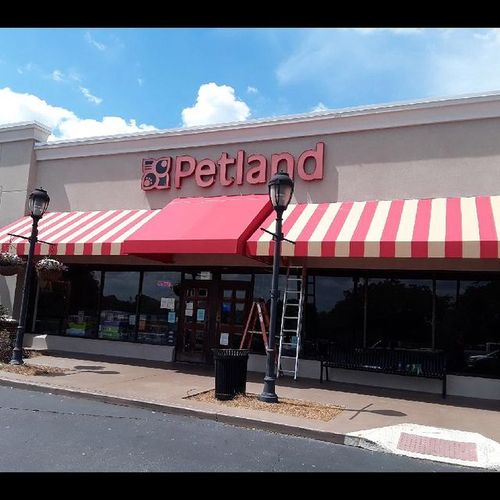 A large storefront awning shades the entrance to the Petland building