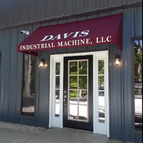 An awning covers the entrance of a building and reads 'Davis Industrial Machine, LLC'