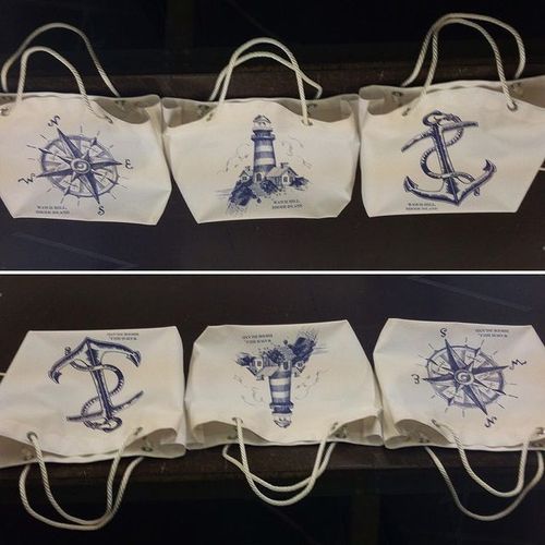 Three canvas bags with images of a compass, a lighthouse, and an anchor